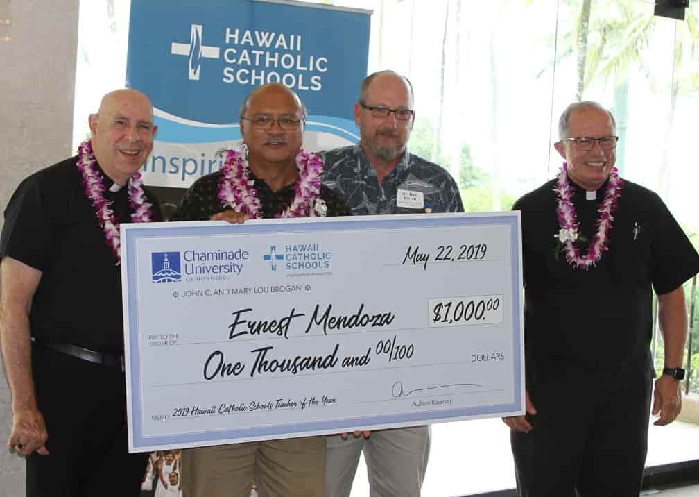 Ernest Mendoza accepting his check for Hawaii Catholic Schools teacher of the year