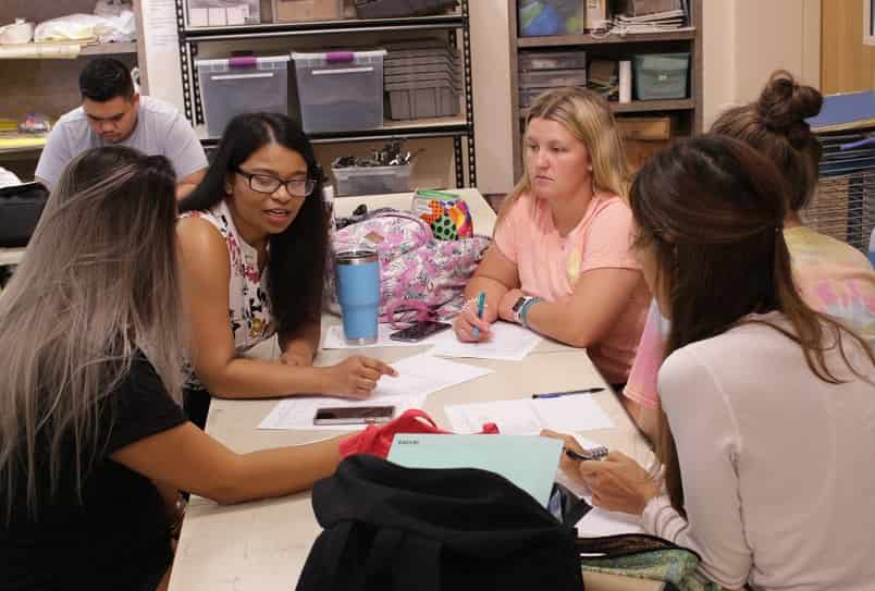 Environmental + Interior Design and Psychology students discussing their interdisciplinary projects