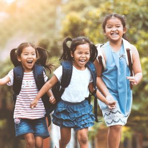 Three elementary students running