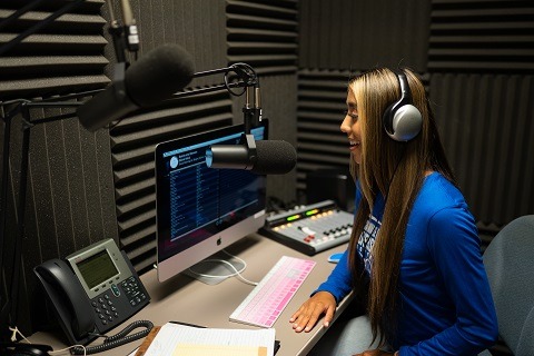 Student Ronni Gallegos in the Radio CUH studio