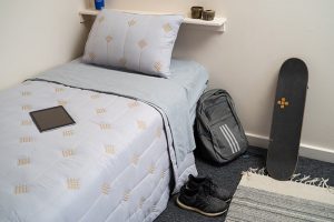 Bed in student residence hall at Chaminade University Hale Lokelani