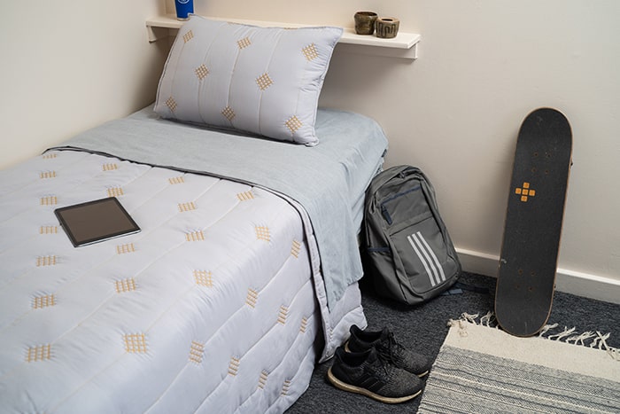 Bed in student residence hall at Chaminade University Hale Lokelani