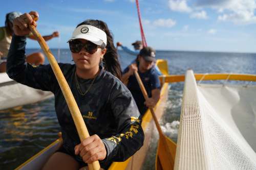 Lucy Lee '23, environmental studies paddling on Hikianalia