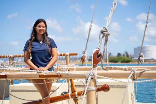 Lucy Lee '23, environmental studies major on Hokulea smiling at camera