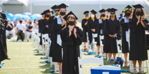 Students standing and being recognized during commencement