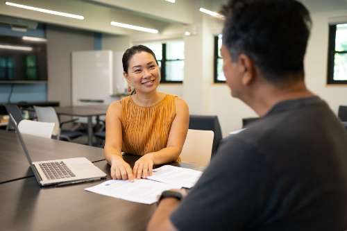 an online undergraduate student meets his advisor in-person to review his academic plan