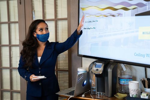 Kailani Torres (E+ID major) presenting her design to Sacred Hearts Academy