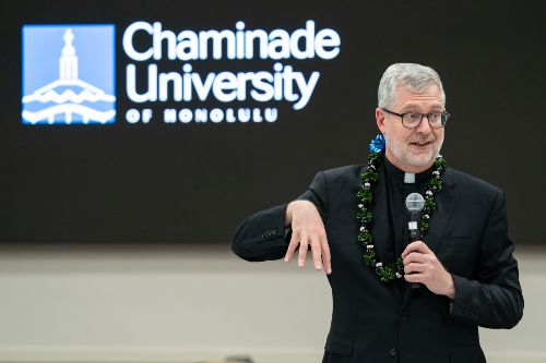 Fr. Dennis Holtschneider speaking to Chaminade faculty and staff