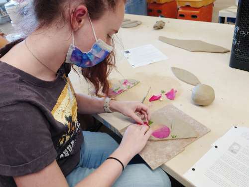 Chaminade student working on a ceramics piece during the Marianist & the Arts workshop