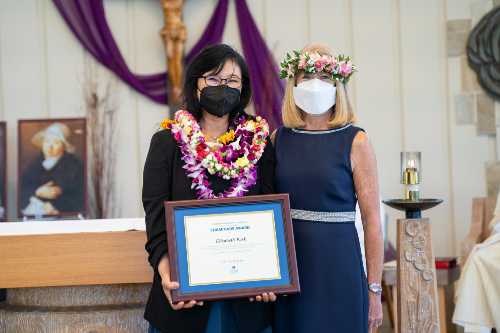 Dr. Elizabeth Park with her Chaminade Award certificate with Dr. Babington posing for a photo