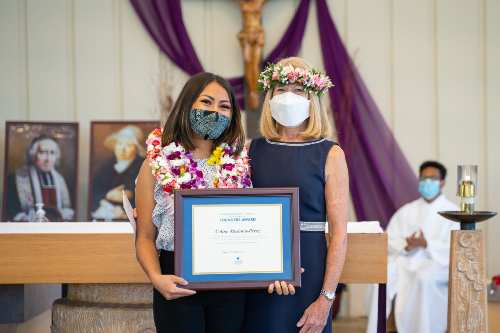 Celine Mesiona-Perez with her Founders' Award certificate with Dr. Babington posing for a photo