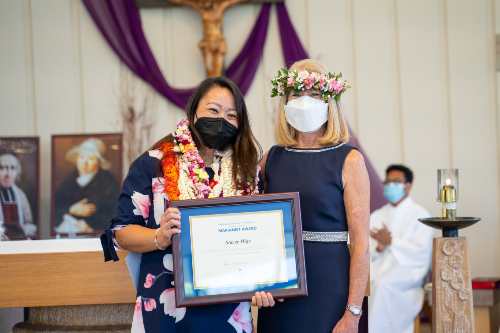 Stacey Higa with her Marianist Award certificate with Dr. Babington posing for a photo