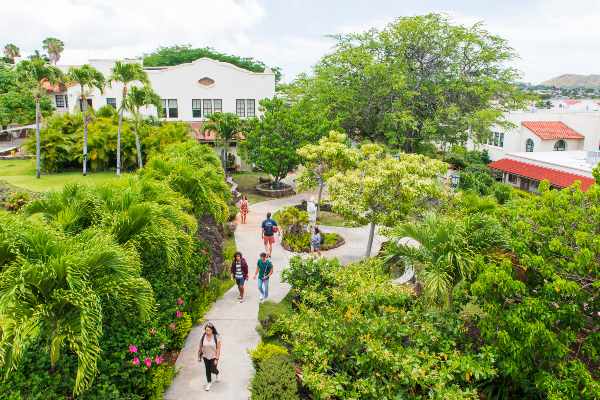 students walking across the Chaminade campus