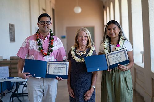 Chaminade President Dr. Lynn Babington presents Dr. Rylan Chong and Kawailani Luat with their respective awards.
