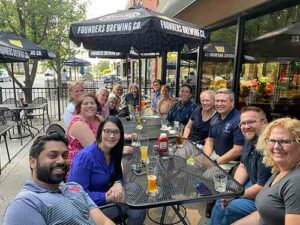 Staff and faculty from Chaminade, St. Mary's and University of Dayton gather for dinner at an outdoor patio.