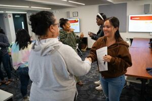 Hale Hoaloha’s R301 became a trading floor, with buyers and sellers brokering deals during a stock market simulation game.