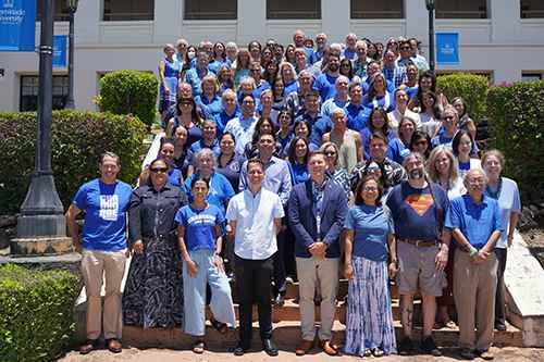 Faculty members gather for a group shot on the steps of Eiben Hall.