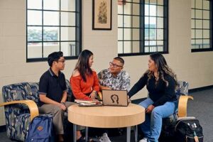 Christian Raquepo, Kryzandreah Español, Easton DelaCruz and Audrey Pilar, from left, discuss an assignment at the Sullivan Family Library.