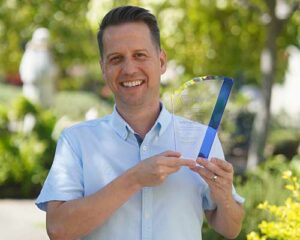 Dr. David Carter holding his AAFS Pathology/Biology Section Award for Achievement in the Forensic Life Sciences.