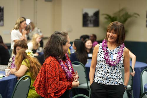 Debbie Ng Furuhashi and Cathy Ching share a laugh before the start of the Scholarship Luncheon.