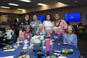 Scholarship Luncheon attendees include, standing from left, Jill Higashi, Kimberly Kameshige, Brianna Gutierrez Aceves and Easton DelaCruz, and, seated from left, Jeannine Wiercinski, Estelle Kelley, Jeannie Rolles and Chaminade President Dr. Lynn Babington.