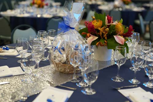 Tables were elegantly set with a floral arrangement as the centerpiece.