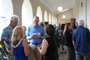 Fr. Chris Wittman talks with Dr. Lynn Babington and her husband Dr. Randy Carpenter, and Tertia Freas.