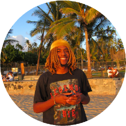 Micah Sanders posing in front of the camera at the beach