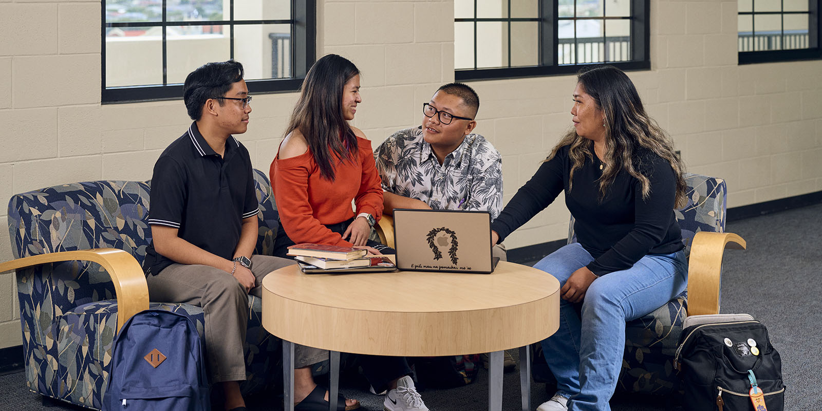 Christian Raquepo, Kryzandreah Español, Easton DelaCruz and Audrey Pilar, from left, discuss an assignment at the Sullivan Family Library.