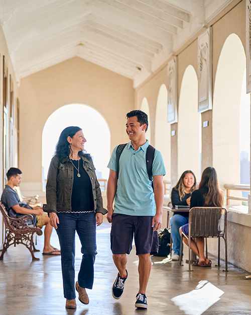 School of Humanities, Art and Design Dean Dr. Cheryl Edelson walks through Henry Hall with senior Sean Lorrenzo.