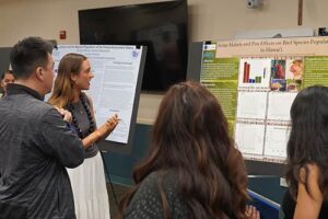 Sydney Danielson explains the effects of avian malaria and avian pox to attendees at the Na Liko Na'auao Symposium.