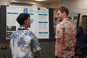 Brandon Koskie, right, discusses his research findings on two fishponds with Anson Ekau, who developed a dashboard for the Maunalua Fishpond Heritage Center.