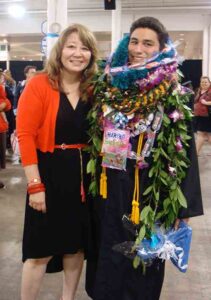 Marlene Baker congratulated Keegan Tomita when he graduated cum laude in 2013.