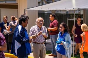 Professor Richard Kido, center, shares a moment with fellow employees.