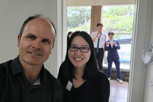 Dr. Eddie Merc takes a selfie with Maryknoll School's Kit-U Wong, who escorted the Trojans to Chaminade.