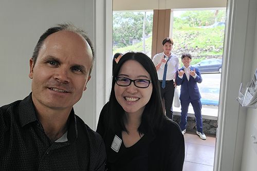 Dr. Eddie Merc takes a selfie with Maryknoll School's Kit-U Wong, who escorted the Trojans to Chaminade.