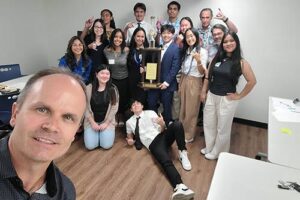 Dr. Eddie Merc with Drs. Annette Santos and Roy Panzarella pose with the Maryknoll Students after their Mini Shark competition.