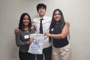 Ethan Hendricks poses with Vaneah Dela Cruz, left, and Megan Collado.