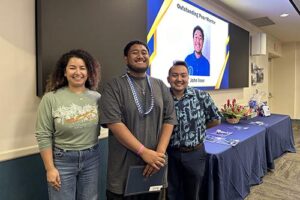 Pono Riddle and Ariz Sánchez pose with Outstanding Peer Mentor Award winner John Iose.