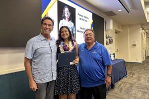 Athletic Director Tom Buning and Women's Softball Coach Kent Yamaguchi pose with Female Student Athlete infielder/catcher Keaolani Takemura-Brehme ’24.