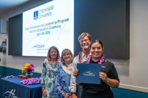 Yazmine Esquivel holds up her One-Year Certificate after learning she had been named this year's Aloha Spirit Award.
