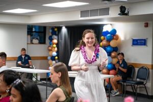 Liz Devine walks toward the podium to accept her Innovation and Entrepreneurship Award.