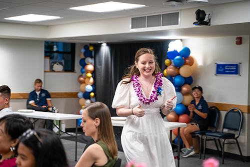 Liz Devine walks toward the podium to accept her Innovation and Entrepreneurship Award.