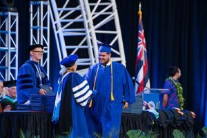 Gabriel Zapata Berrios shakes the hand of Dr. Lynn Babington.