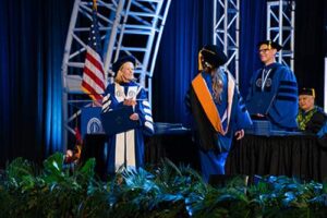 Drs. Lynn Babington and Lance Askildson present graduates with their degrees.