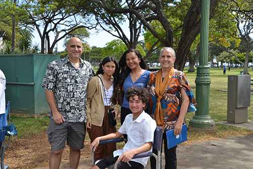 Shandry Lopes, far right, waits in line with family members to enter the Waikiki Shell.
