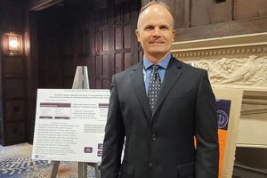 Dr. Eddie Merc stands prepare to present his research findings in the Peregrine Best Practices Poster Competition.