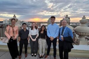Wera Panow-Loui and Dr. Eddie Merc flank students, from left, Alexander Hernandez, Liz Devine, Kelsey Sablan and Ross Reeves.