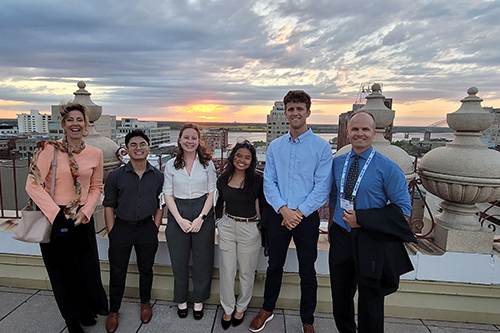 Wera Panow-Loui and Dr. Eddie Merc flank students, from left, Alexander Hernandez, Liz Devine, Kelsey Sablan and Ross Reeves.