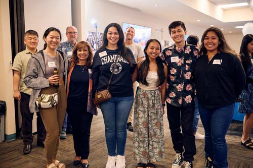 Drs. Hans Chun, Dale Fryxell and Saint Louis teacher Charlie Clausner, in the background from left, mingle with alumni Carina Lee MEd '23, Be-Jay Kodama '86 and MBS '16, Brittaney Fitzgerald '22, Nicole Kegine Aguinaldo '24, Marlon Francisco '24 and Audrey Pilar '24.